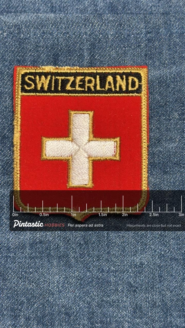 Switzerland Flag Iron On Patch: Red & Gold Shield - Vintage Travel Souvenir Accessory with ruler overlay for size reference