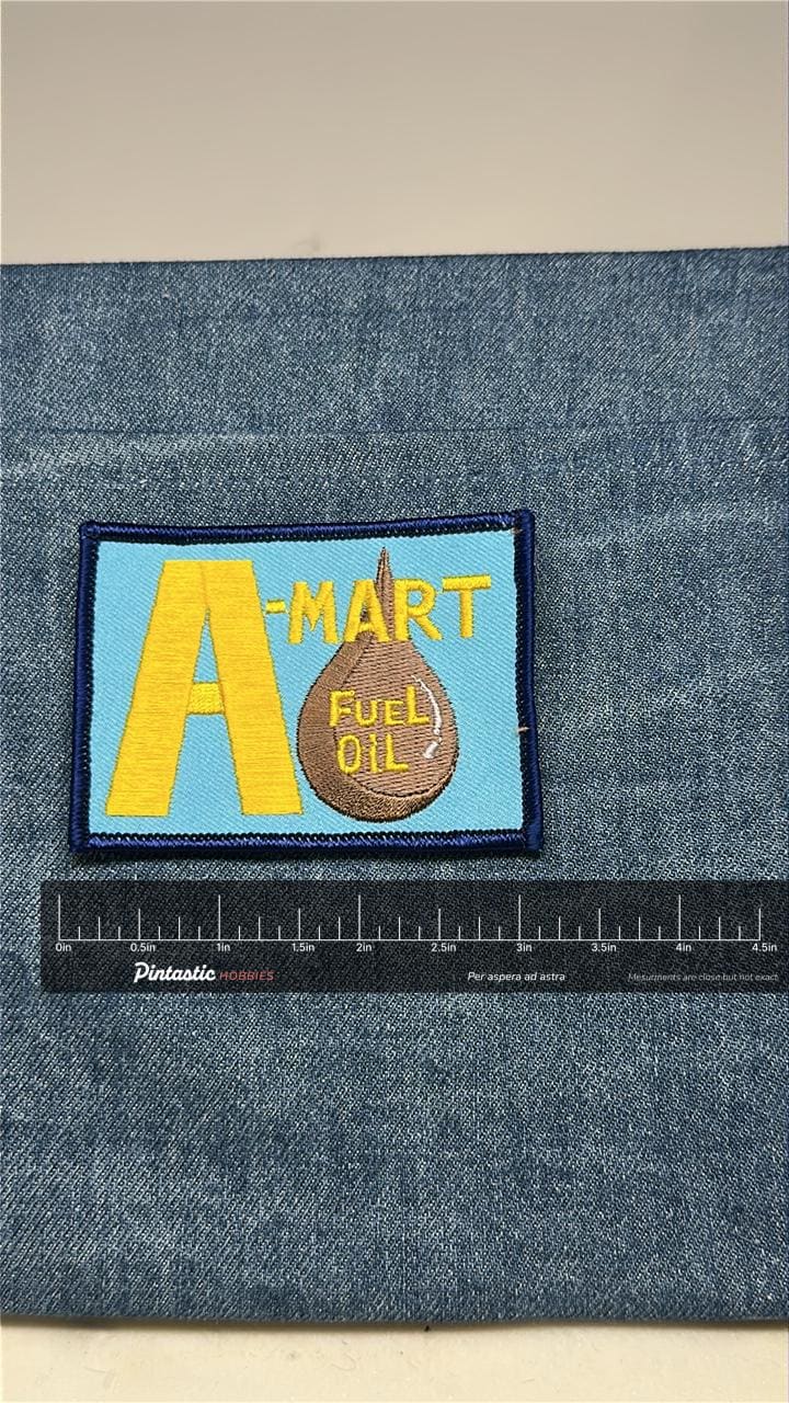 A-Mart Fuel Oil Patch: Sew-On Blue/Yellow - Retro Workwear Accessory with ruler overlay for size reference