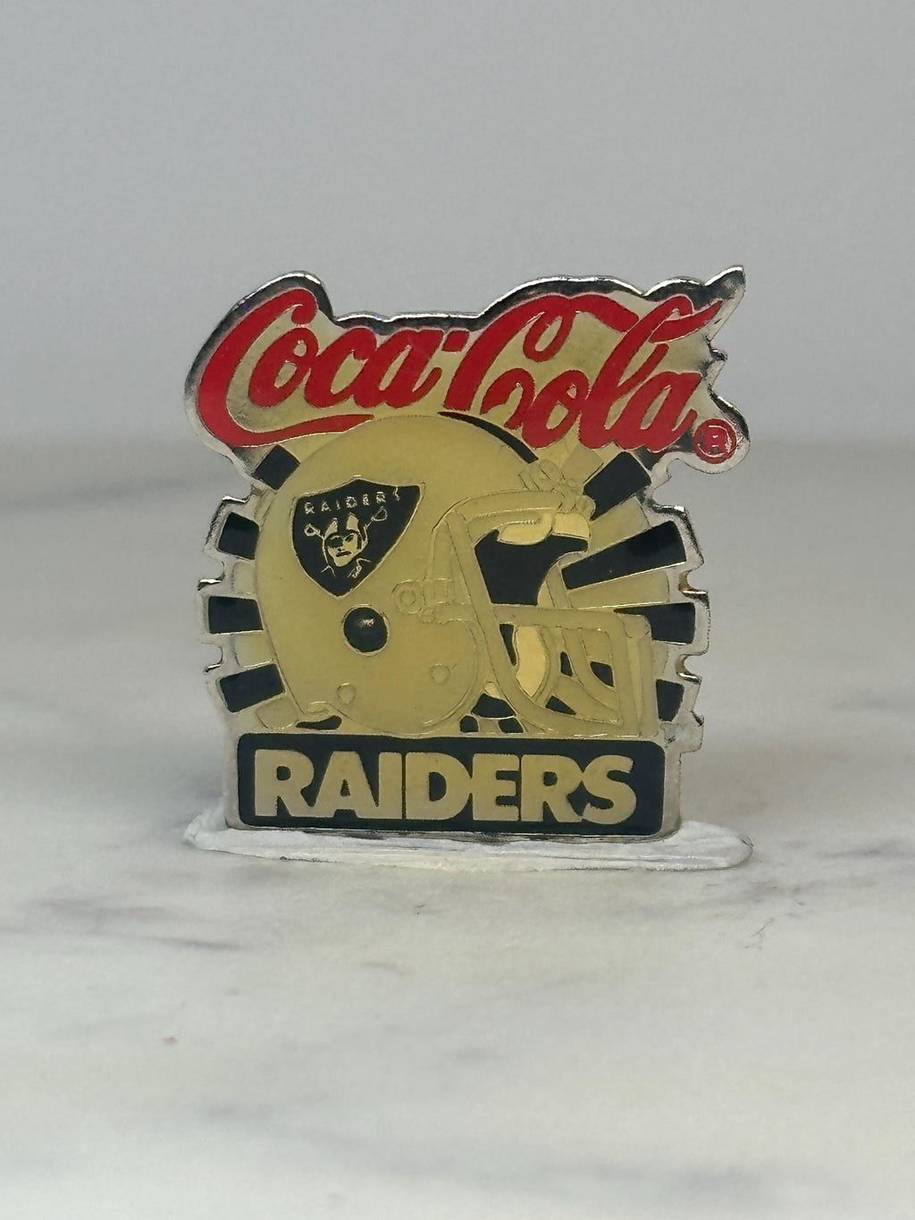 Coca-Cola Raiders Pin: Gold & Black Enamel - Vintage Sports Accessory