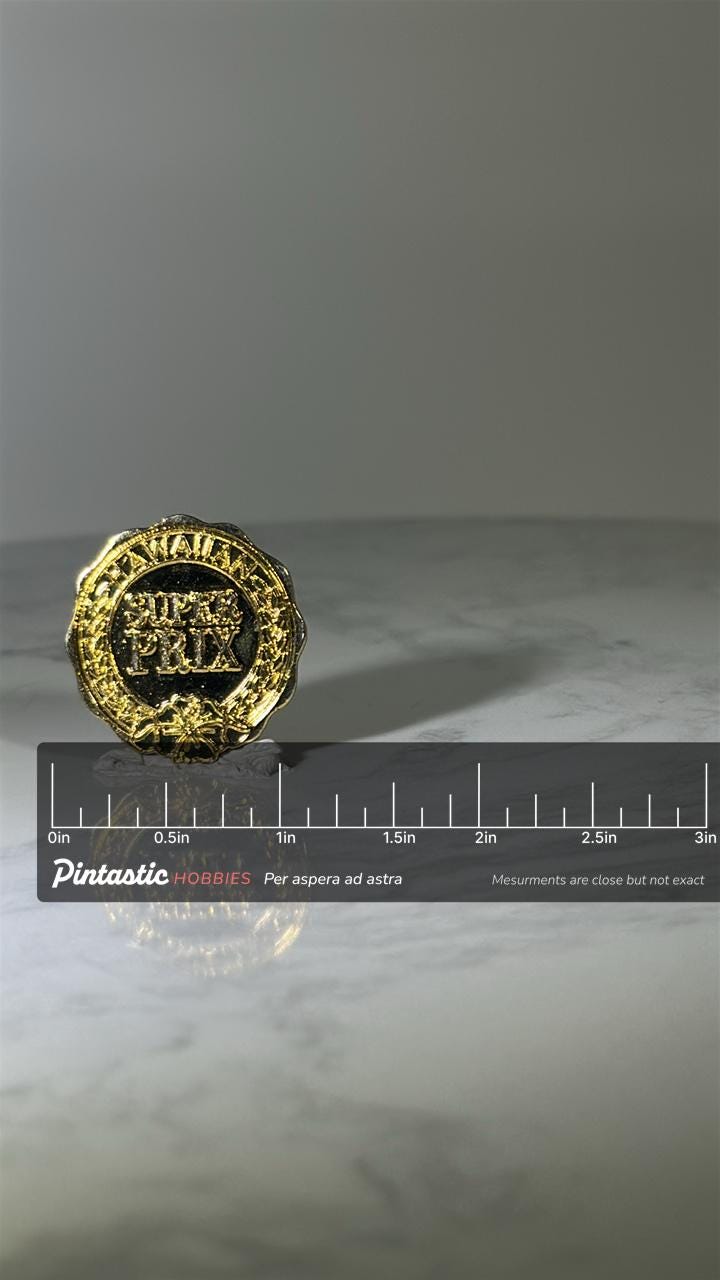 Hawaiian Super Prix Pin: Gold Tone Laurel Style - Racing Event Accessory with ruler overlay for size reference