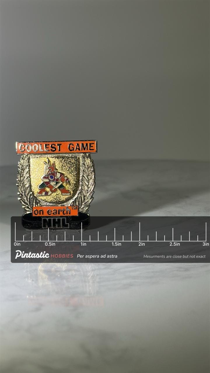 NHL Coyotes Lapel Pin: Gold Tone Enamel Finish - Vintage Hockey Accessory with ruler overlay for size reference