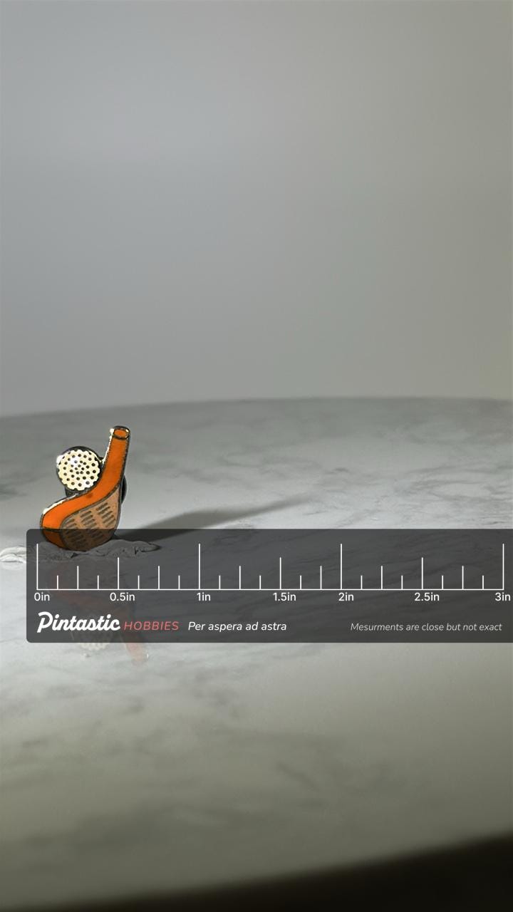 Vintage Golf Driver & Ball Pin: Orange Enamel Metal - Retro Sports Accessory with ruler overlay for size reference