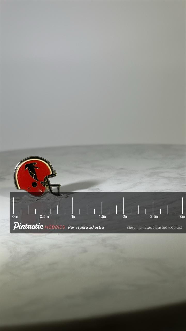 Atlanta Falcons Helmet Pin: Red Enamel - Vintage Sports Accessory with ruler overlay for size reference