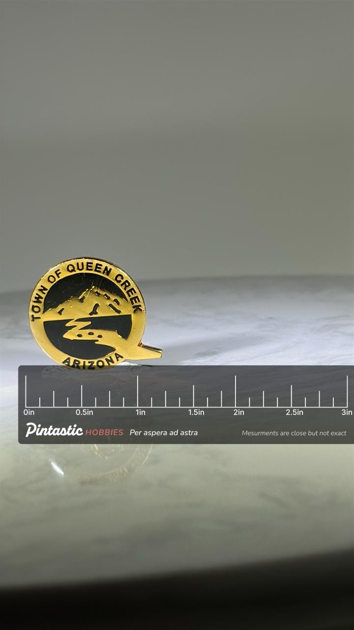 Town of Queen Creek Arizona Pin: Gold and Black Enamel - Southwest Souvenir Accessory with ruler overlay for size reference