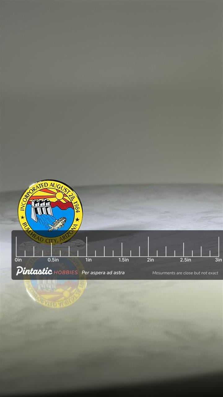 Bullhead City Arizona Pin: Colorful Enamel Seal - 1980s Souvenir Accessory with ruler overlay for size reference