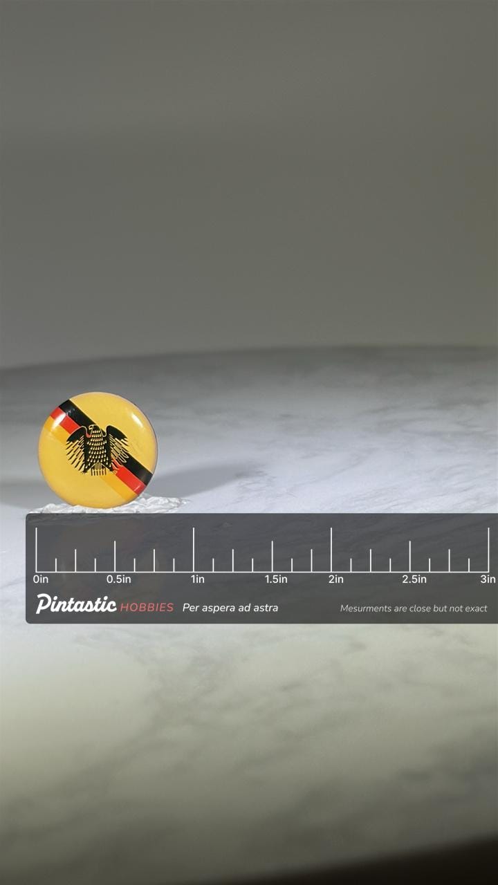 German Eagle Emblem Pin: Yellow Gloss Enamel - Vintage Patriotic Accessory with ruler overlay for size reference