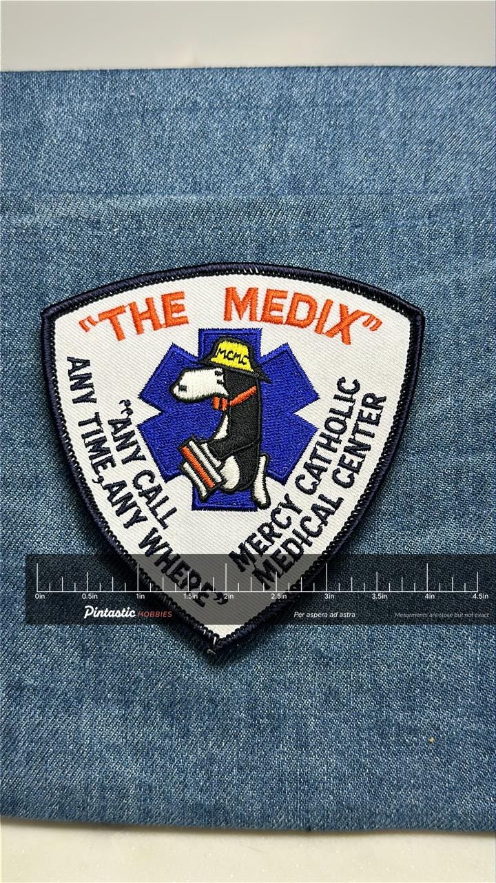 The Medix EMS Collectable Iron-On Patch: Embroidered Shield - Medical Rescue Accessory with ruler overlay for size reference