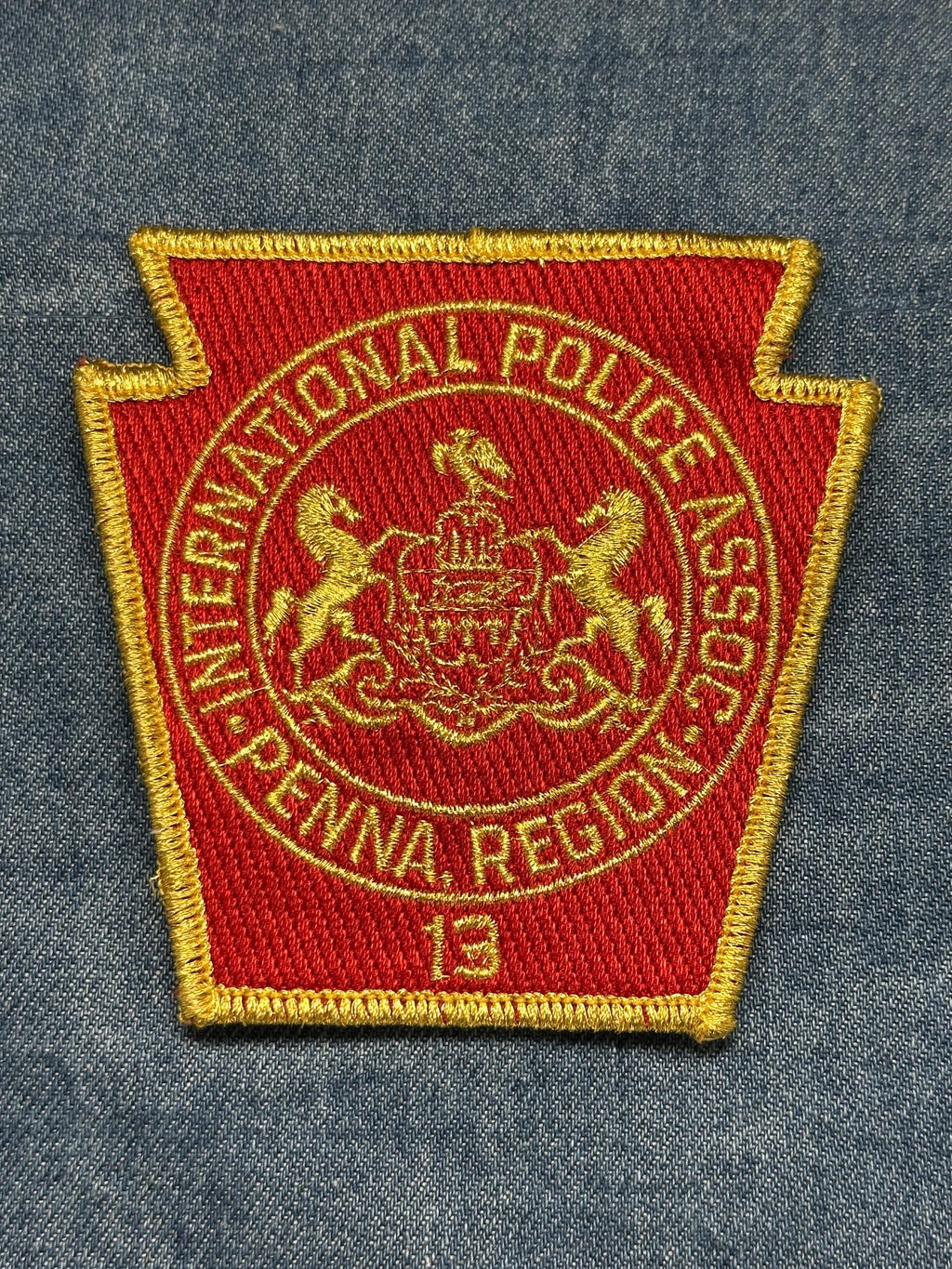 International Police Assoc Collectable Patch: Sew-On Red Gold - Law Enforcement Accessory