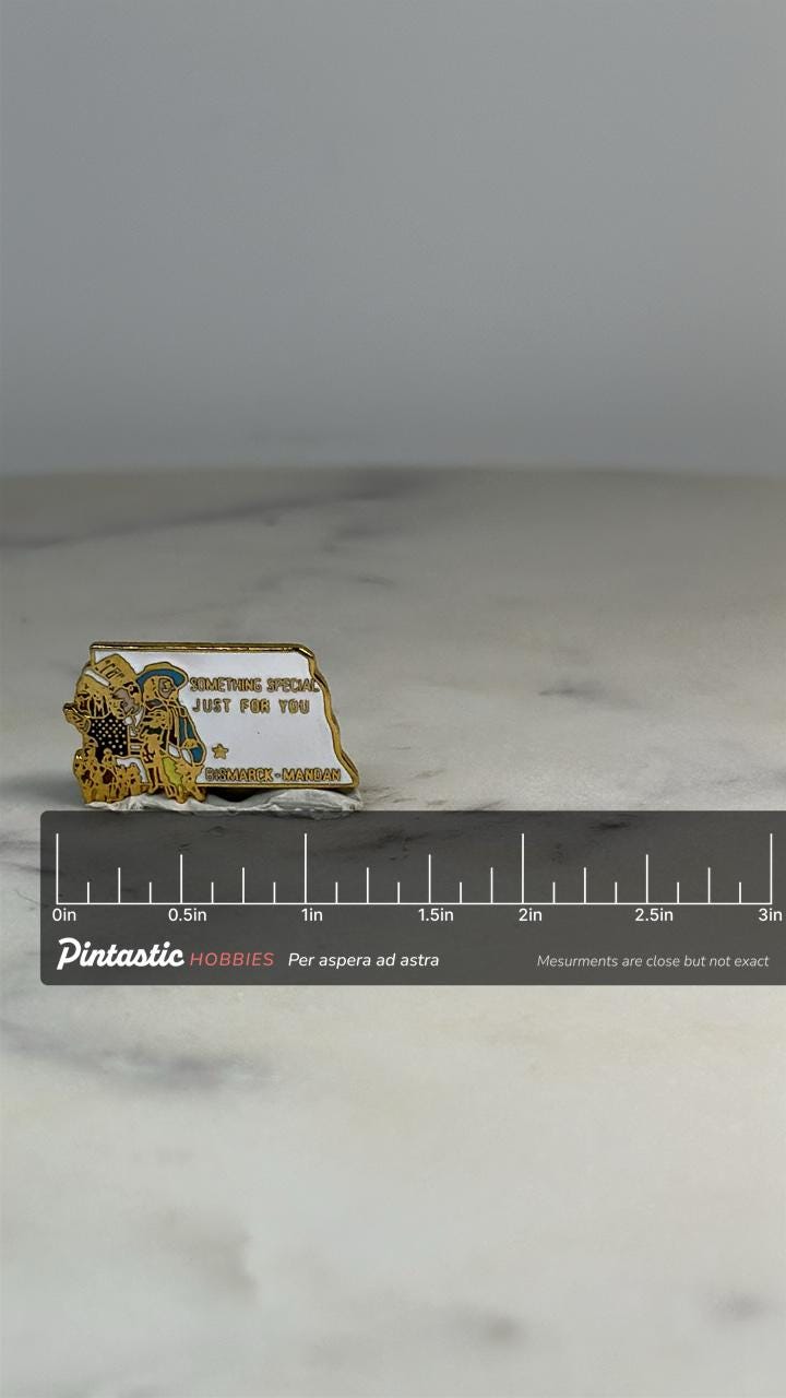 Bismarck-Mandan Souvenir Pin: Gold Enamel - Vintage State Accessory with ruler overlay for size reference