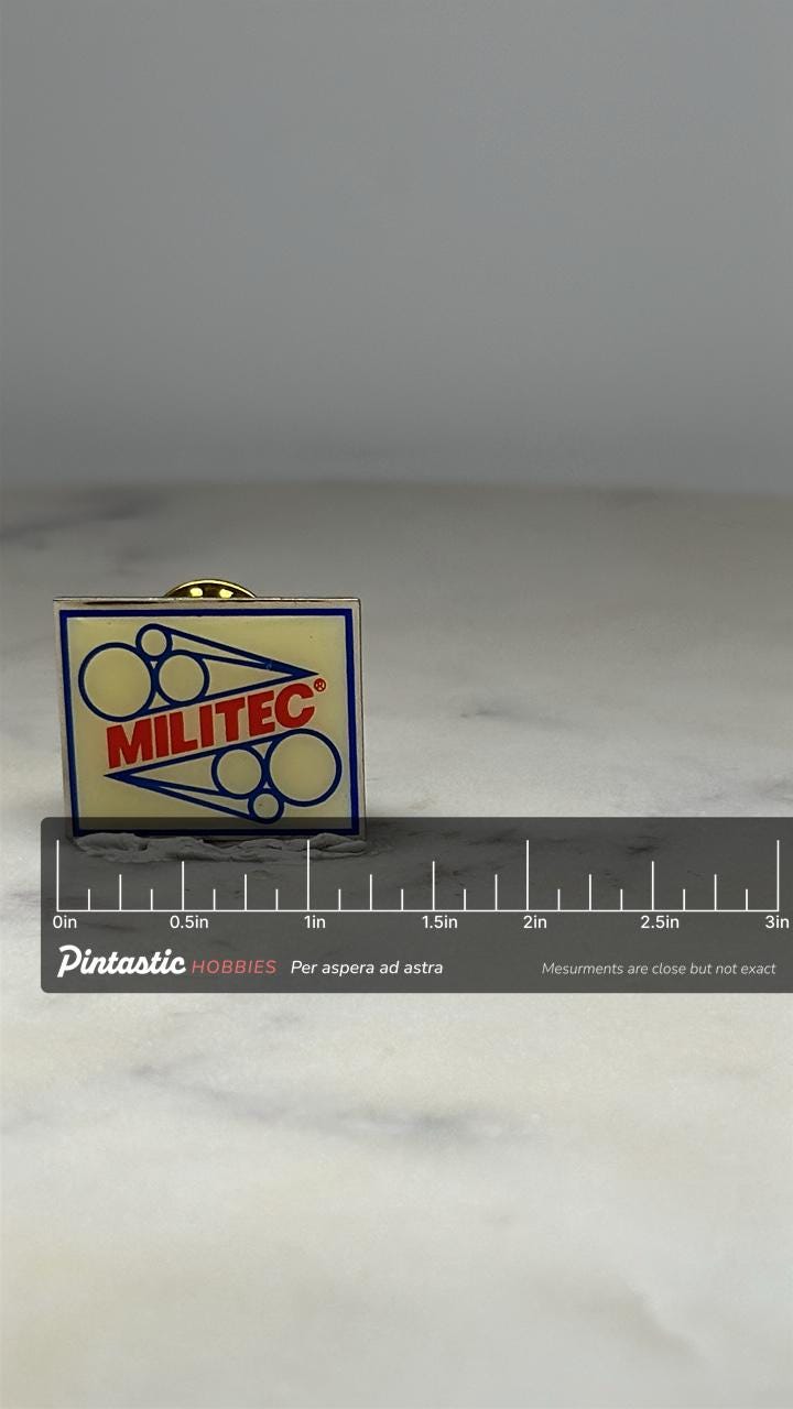 Militec Company Logo Pin: Red Blue Enamel - Industrial Career Accessory with ruler overlay for size reference