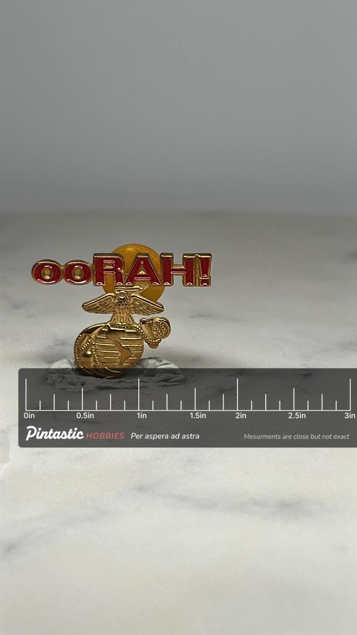 USMC OORAH Pin: Gold & Red Enamel - Military Tribute Accessory with ruler overlay for size reference