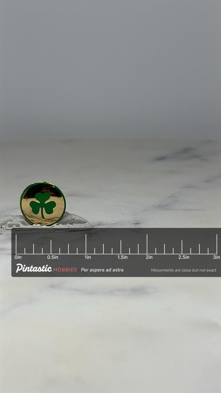 Shamrock Enamel Pin: Gold and Green Finish - Vintage Luck Accessory with ruler overlay for size reference