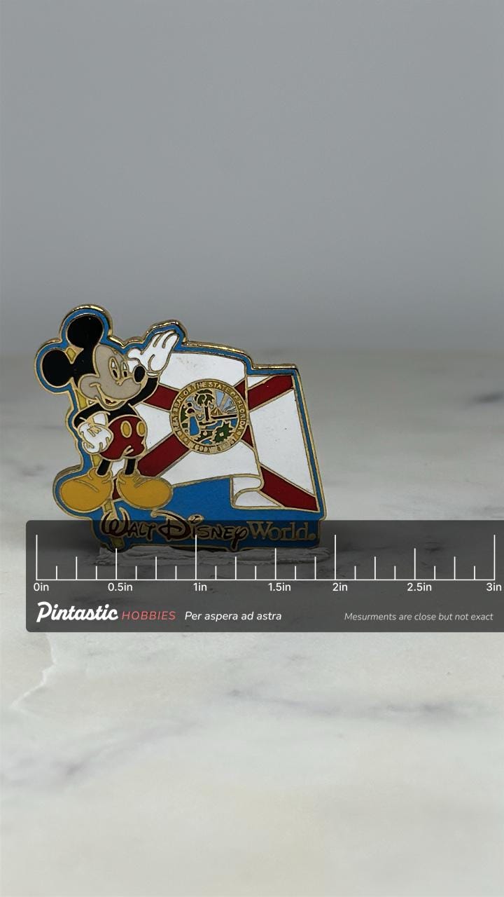 Florida State Disney Pin: Mickey Flag Enamel - Souvenir Travel Accessory with ruler overlay for size reference