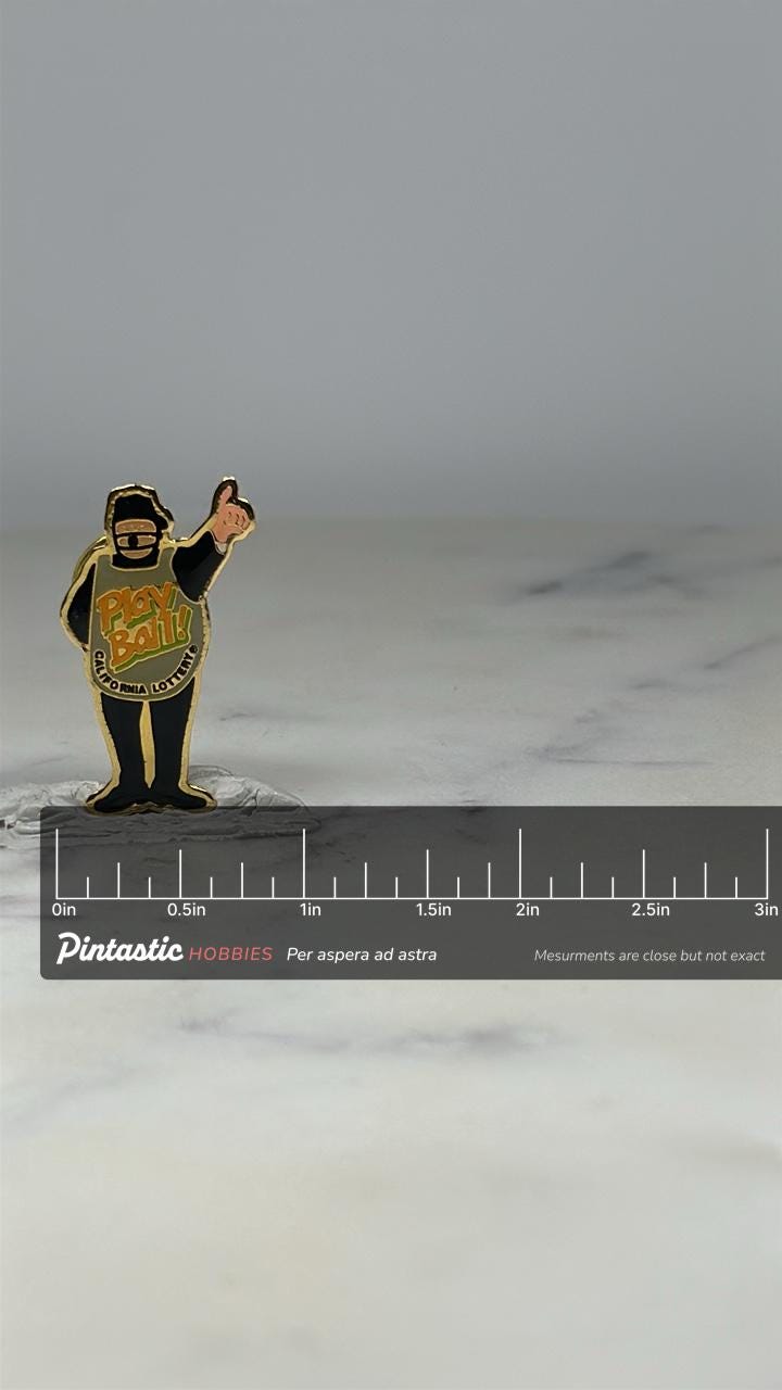 Play Ball Umpire Pin: Black Gold Enamel - California Lottery Accessory with ruler overlay for size reference