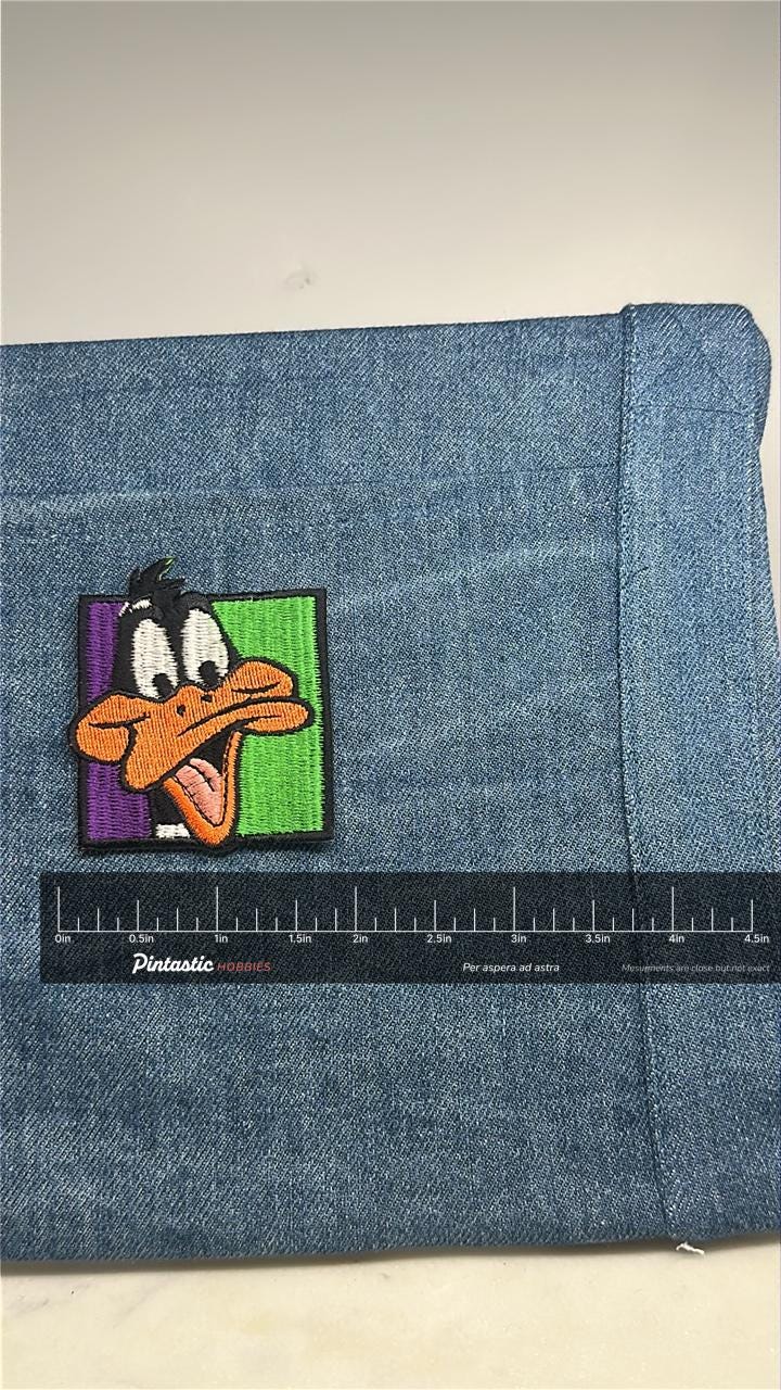 Daffy Duck Collectable Patch: Bold Color Block - Cartoon Classic Accessory with ruler overlay for size reference
