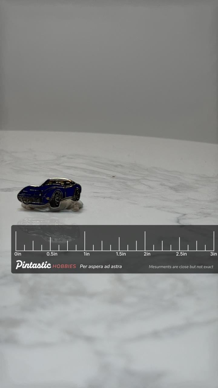 Vintage Corvette Stingray Enamel Pin – Blue Classic 1970s Sports Car Lapel Pin – Retro Muscle Car Collectible with ruler over