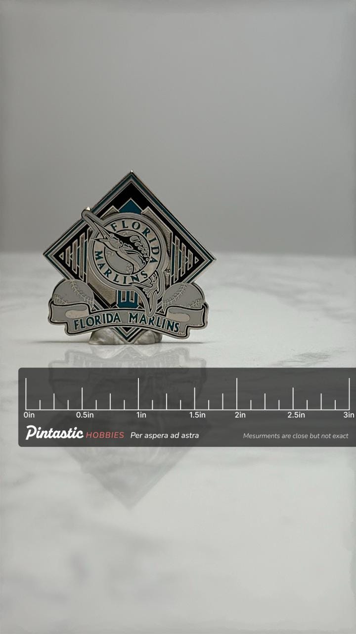 Florida Marlins Baseball Pin: Silver & Teal Enamel - MLB Collectible Accessory with ruler overlay for size reference