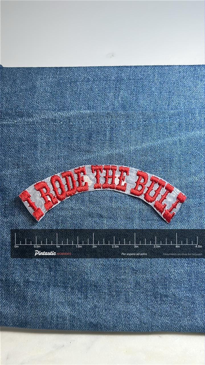I Rode the Bull Collectable Patch: Red Text Curve - Western Novelty Accessory with ruler overlay for size reference