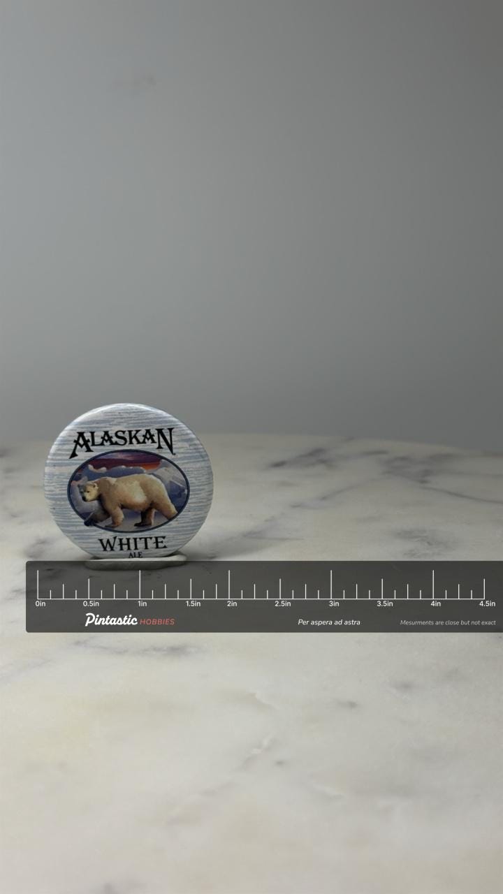 Alaskan White Ale Beer Button Pin: Polar Bear Scenic - Brewery Souvenir with ruler overlay for size reference