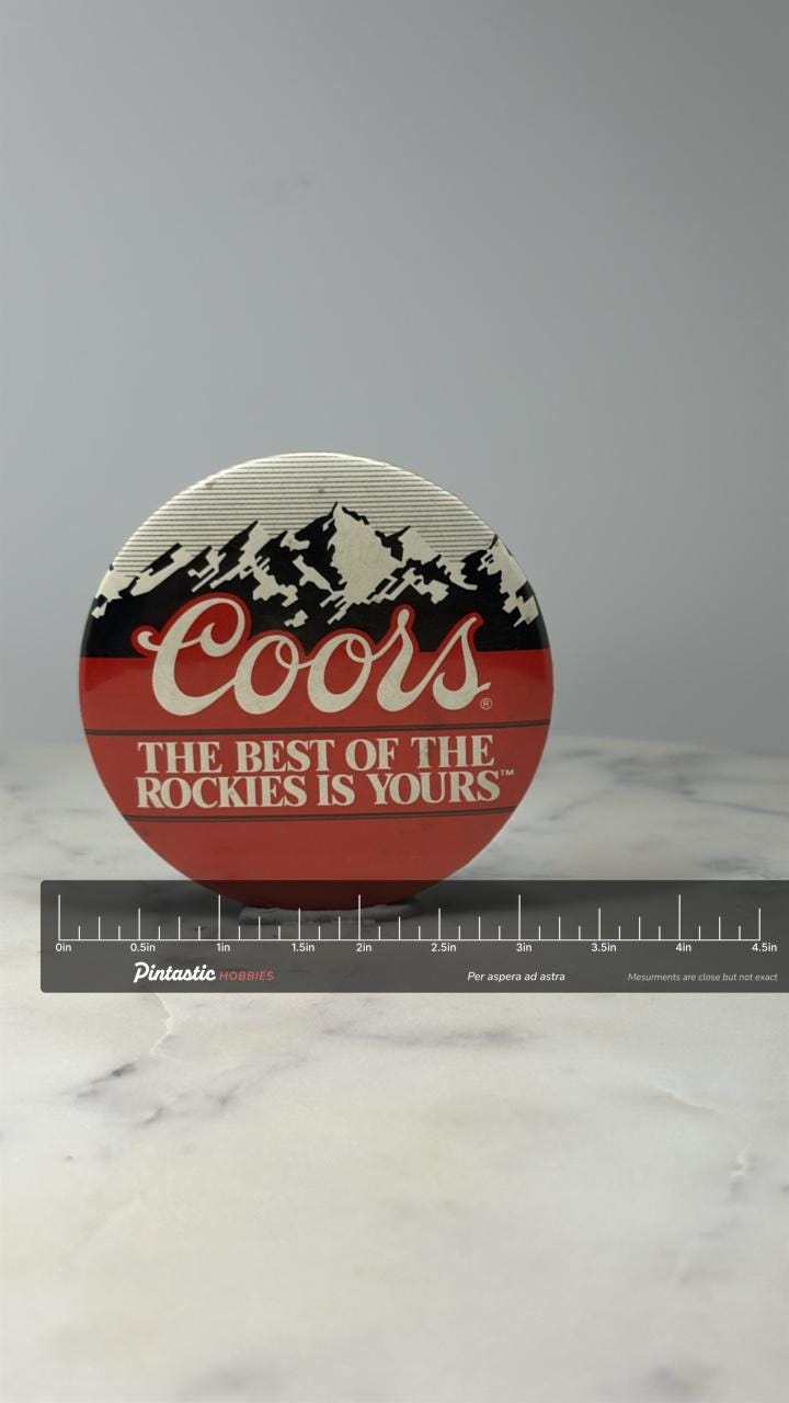 Coors Beer Button Pin: Red White Black - 1980s Bar Accessory with ruler overlay for size reference