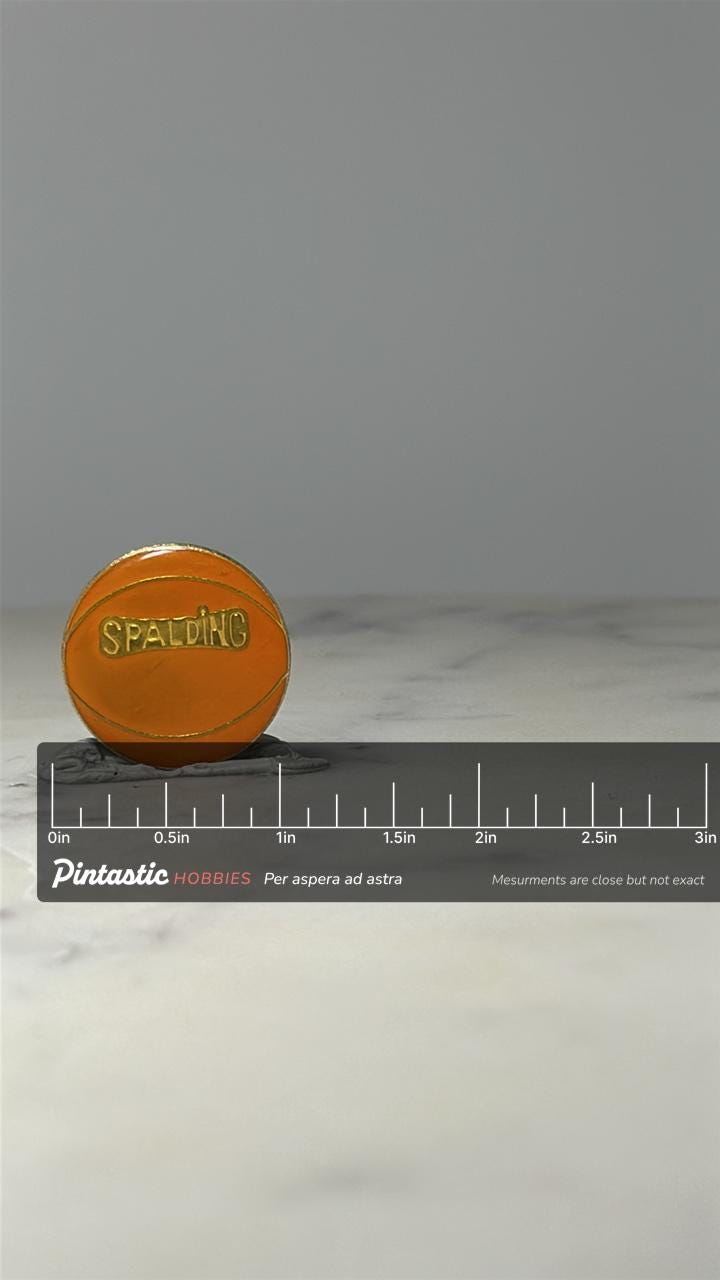Spalding Basketball Lapel Pin: Orange Enamel - Vintage Sports Accessory with ruler overlay for size reference