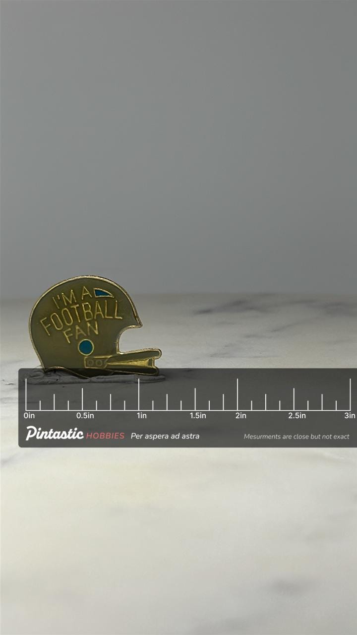 Football Helmet Pin: Gold Tone Enamel - Sports Fan Accessory with ruler overlay for size reference