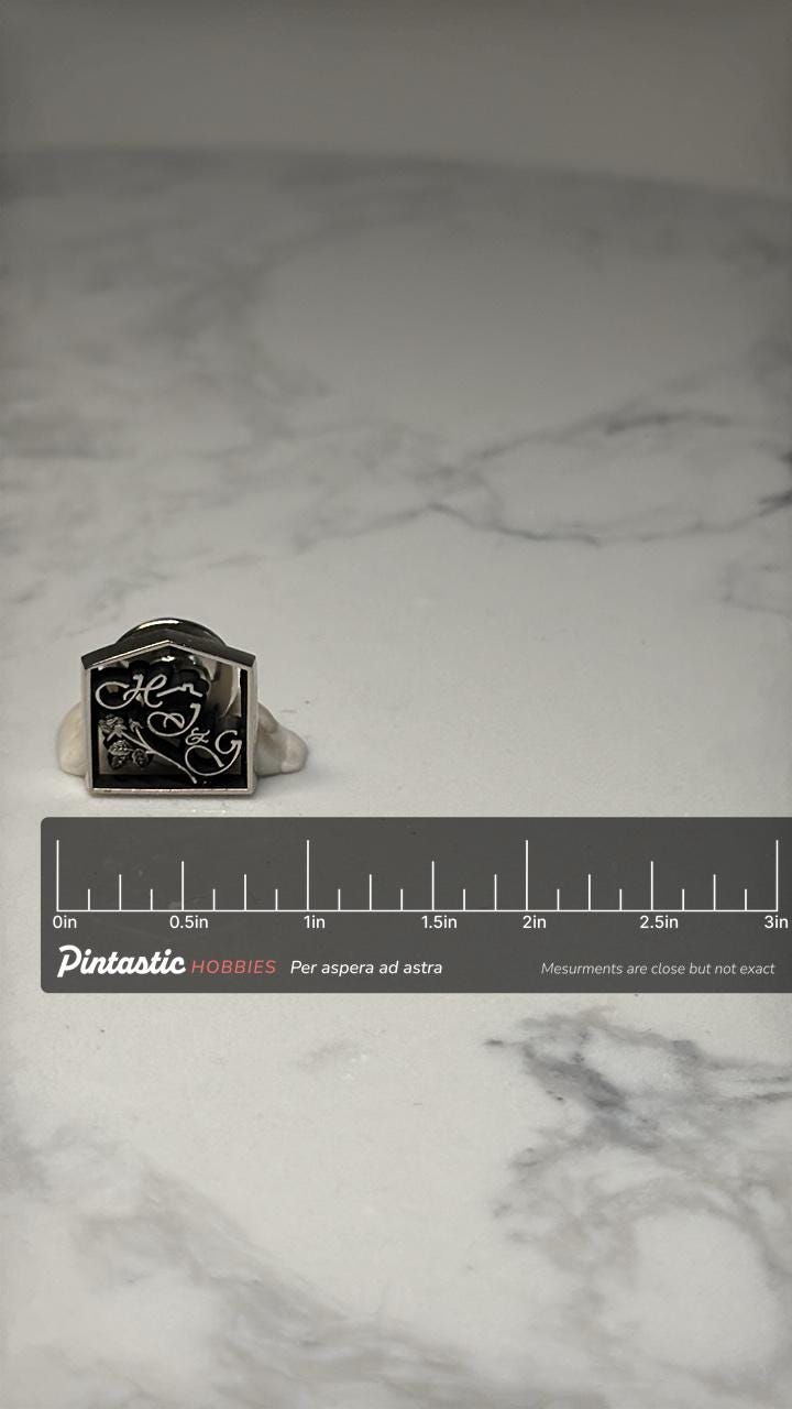 Vintage HJ&G Logo Pin: Silver Tone Black Enamel Brooch – Vintage Doll Collector Badge with ruler overlay for size reference