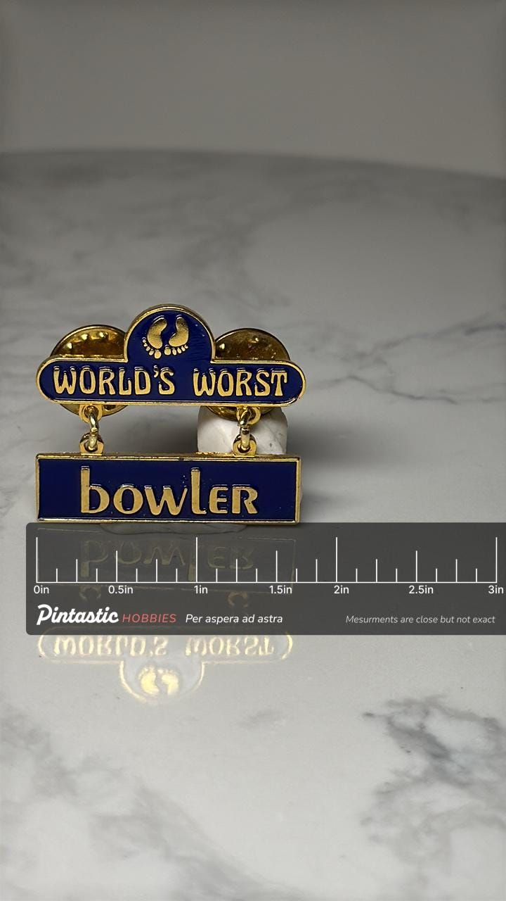 World's Worst Bowler Dangle Pin: Blue Gold Enamel - Novelty Award with ruler overlay for size reference