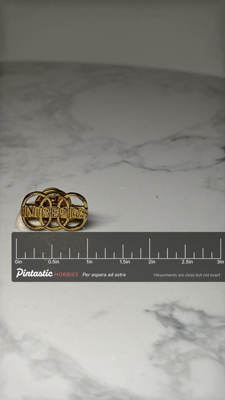 Vintage INTREPIDS Lapel Pin: Gold Tone Team Club Badge – Rings Design with ruler overlay for size reference