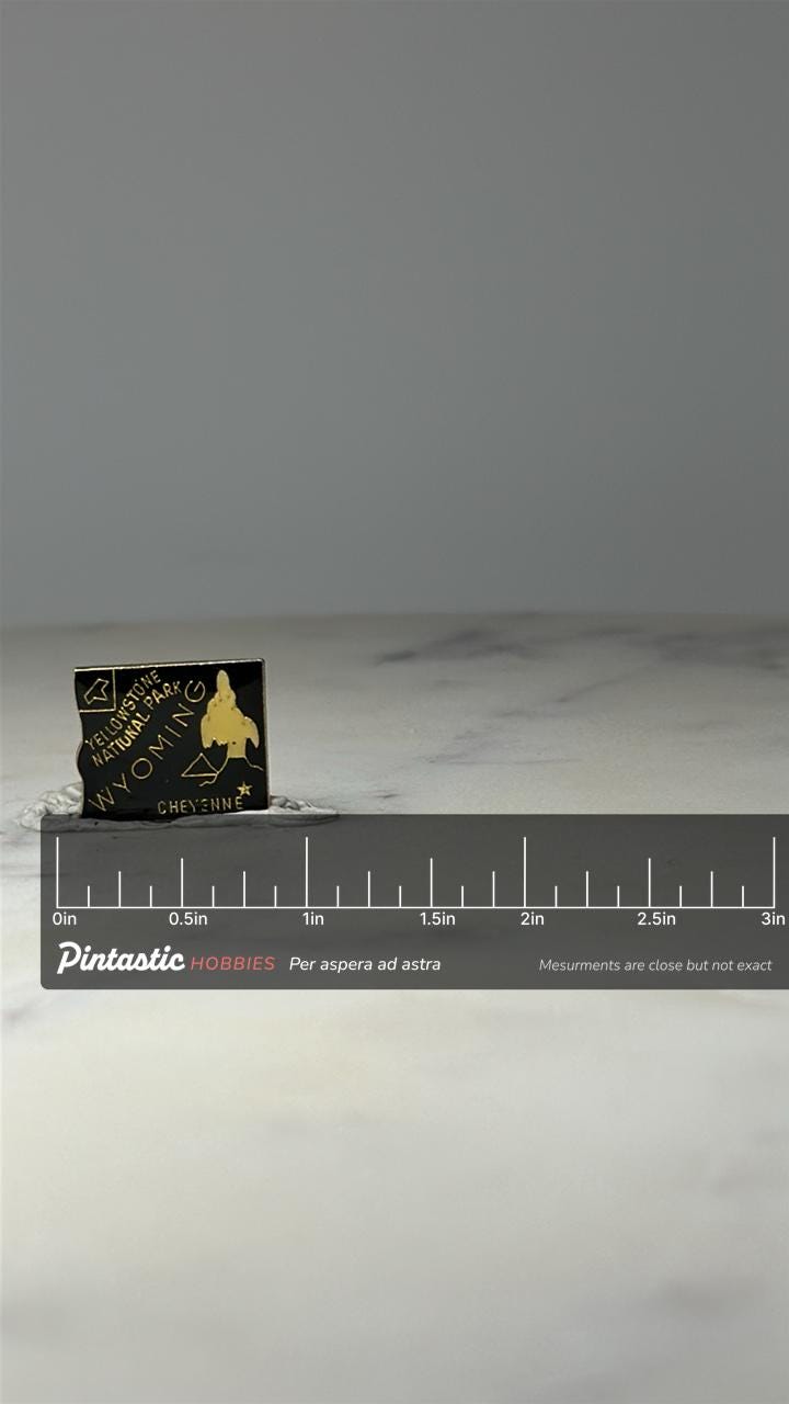 Yellowstone National Park Souvenir Pin: Black & Gold - Wyoming Travel Accessory with ruler overlay for size reference