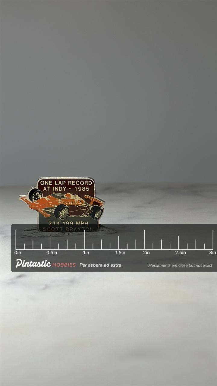 Indy 500 Race Car Pin: Orange Enamel - 1985 Racing Record with ruler overlay for size reference