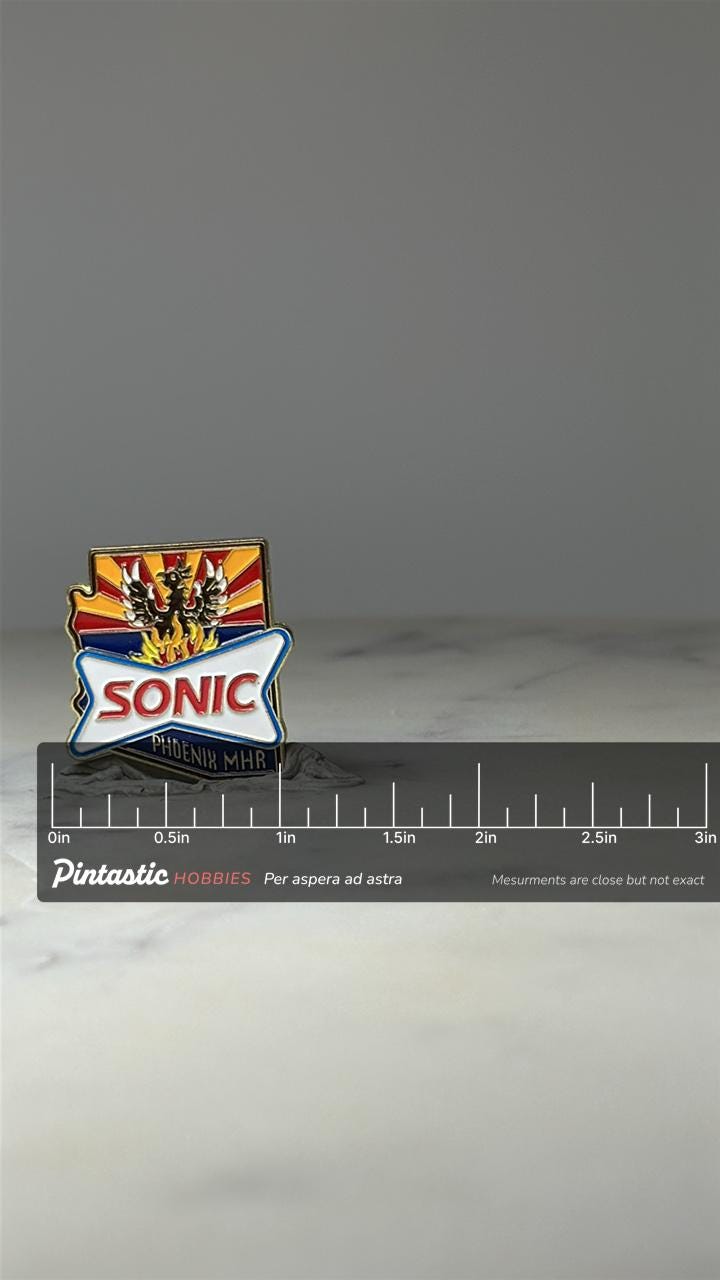 Sonic Phoenix MHR Enamel Pin: Red Yellow Shield - AZ Travel Accessory with ruler overlay for size reference