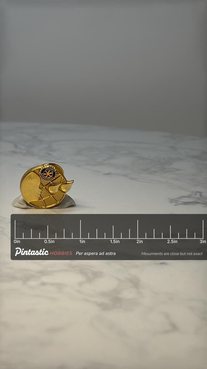 Vintage Rotary International Globe Pin: Gold Tone - Service Club Accessory with ruler overlay for size reference