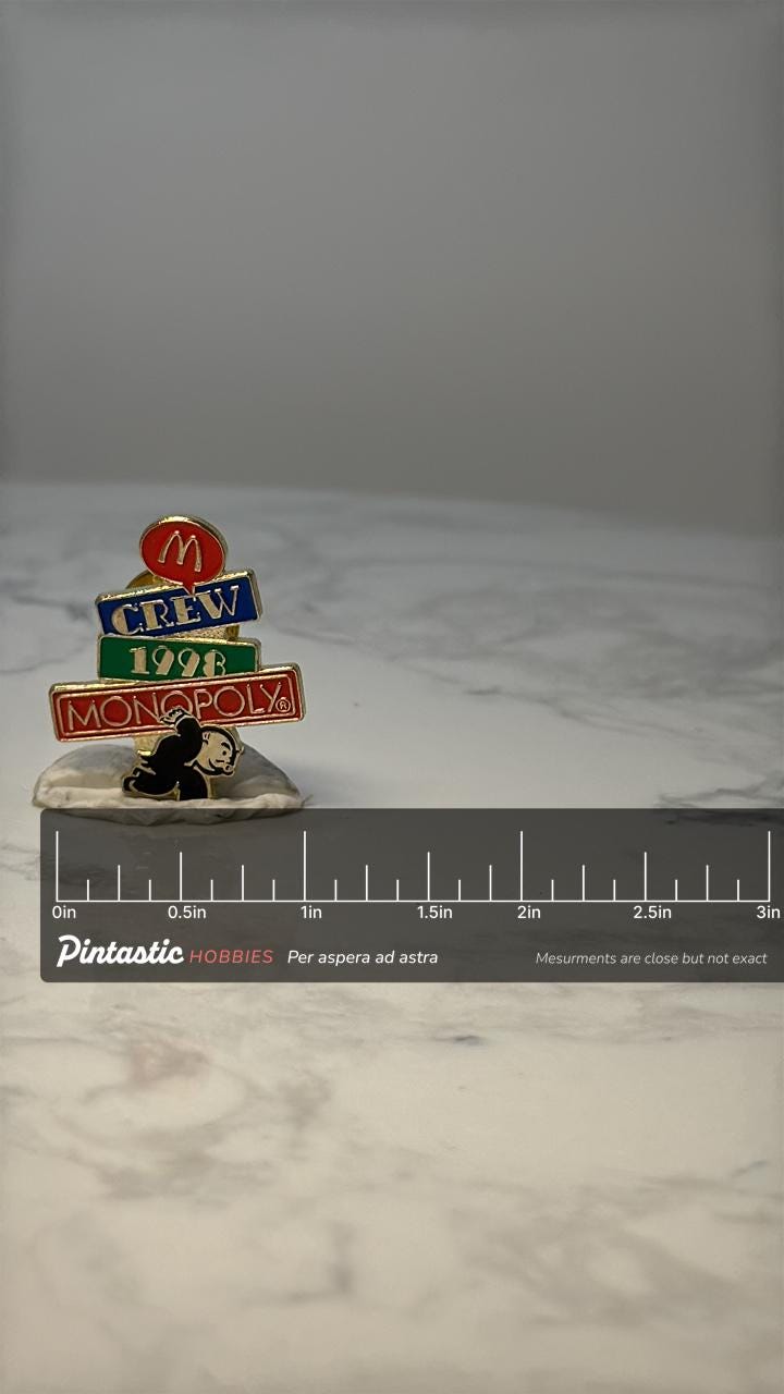 Vintage McDonalds Monopoly Crew Pin: Gold Tone Enamel - 1998 Promo with ruler overlay for size reference