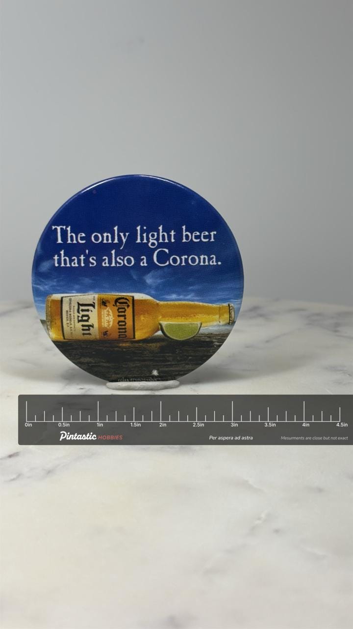 Corona Light Beer Button Pin: Blue Glossy - 2000s Bar Accessory with ruler overlay for size reference