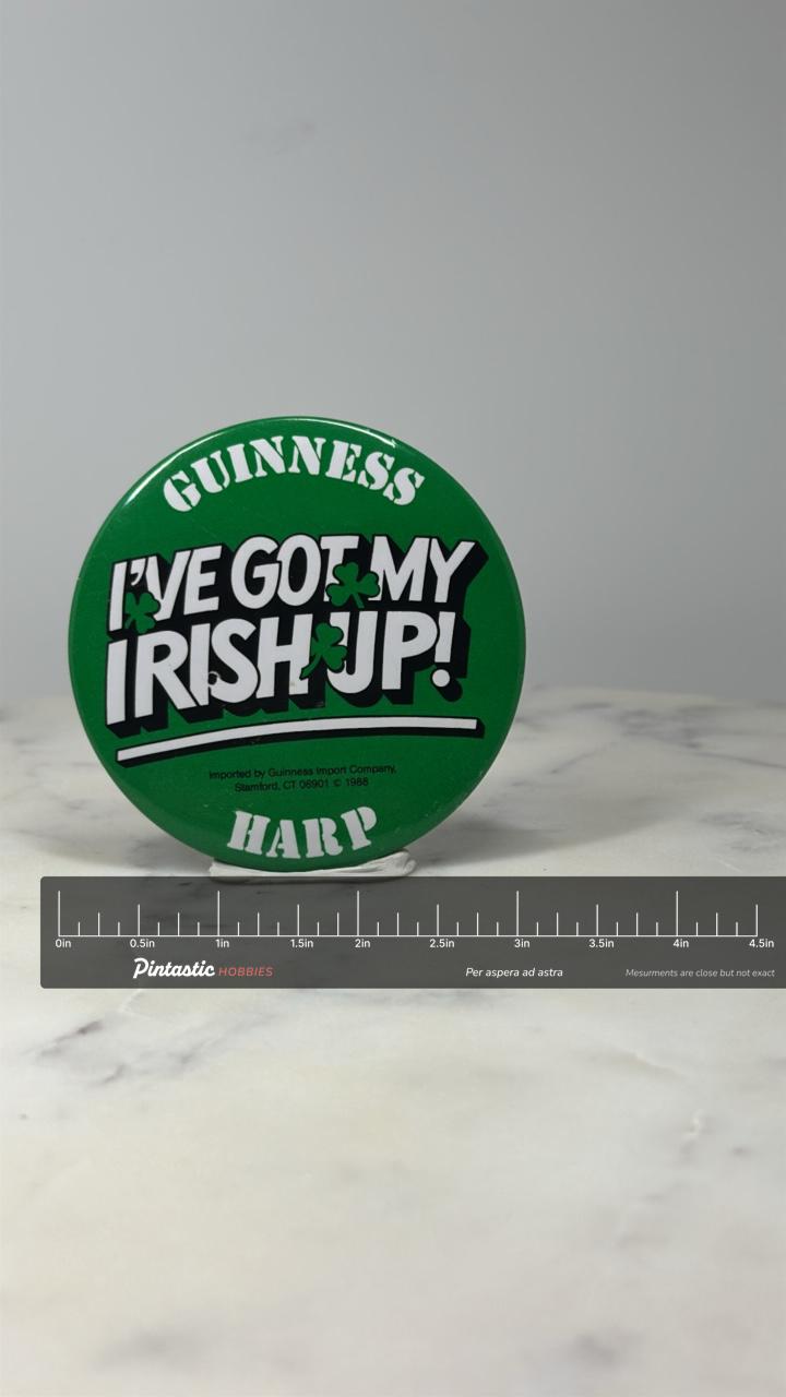 Guinness Irish Pride Pin: Green Shamrock Button - 1988 St Patricks Day Barware with ruler overlay for size reference