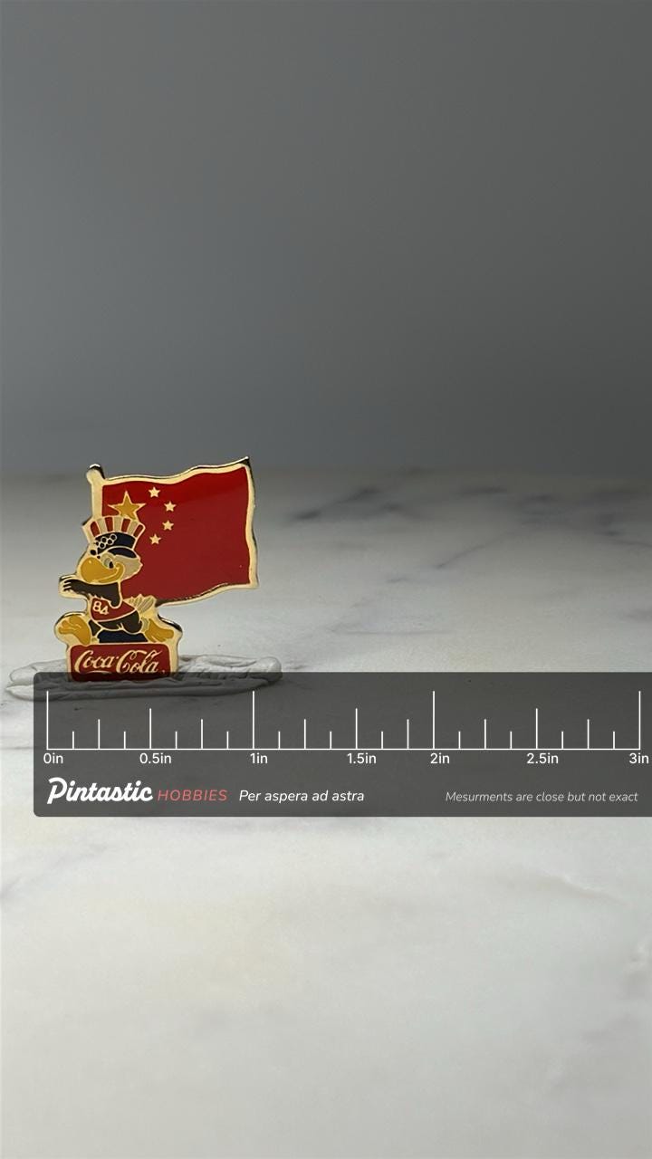 Coca Cola Olympic Bird Pin: Red Enamel - 1984 China Flag Accessory with ruler overlay for size reference