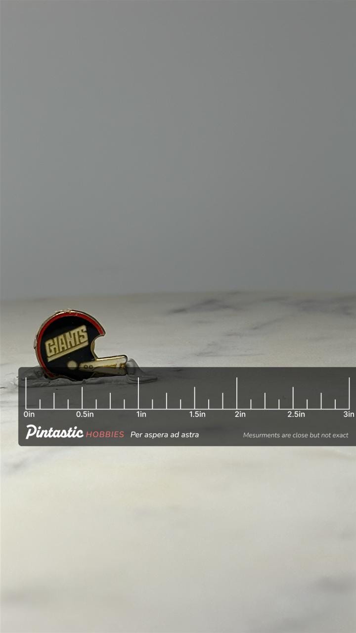 New York Giants Helmet Pin: Blue Enamel - Vintage NFL Accessory with ruler overlay for size reference