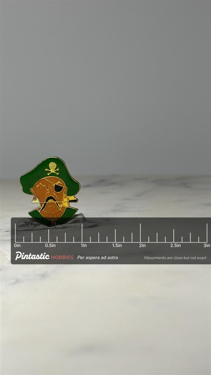 Pirate Character Enamel Pin: Green & Gold Metal - Vintage Novelty Accessory with ruler overlay for size reference