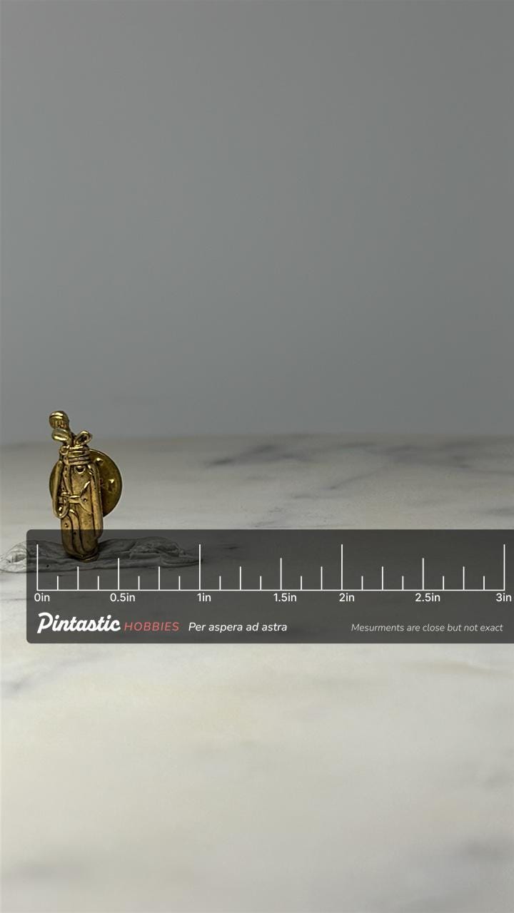 Golf Bag with Clubs Lapel Pin: Gold Tone - Vintage Sports Accessory with ruler overlay for size reference