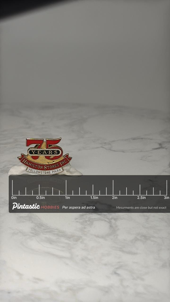 Hamilton Stores 75 Years Pin: Red Gold Enamel - Yellowstone Park with ruler overlay for size reference