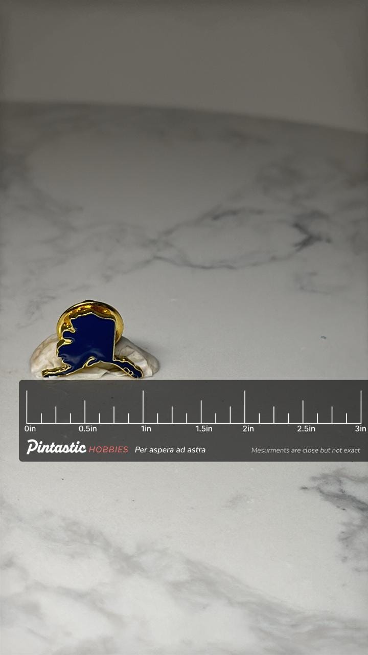 Alaska State Map Lapel Pin: Blue Enamel Gold Tone - Travel Souvenir with ruler overlay for size reference