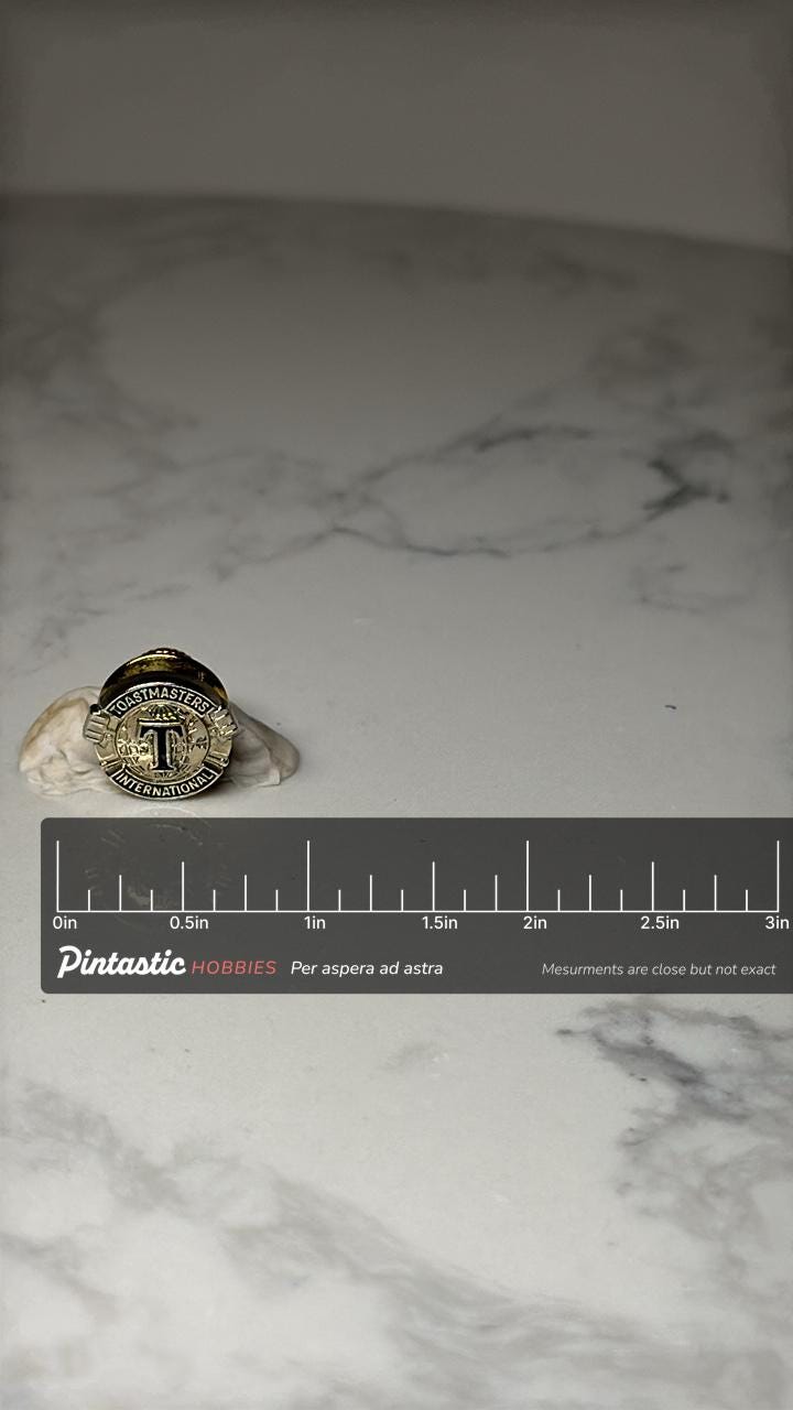 Toastmasters International Lapel Pin: Gold Tone - Public Speaking Accessory with ruler overlay for size reference