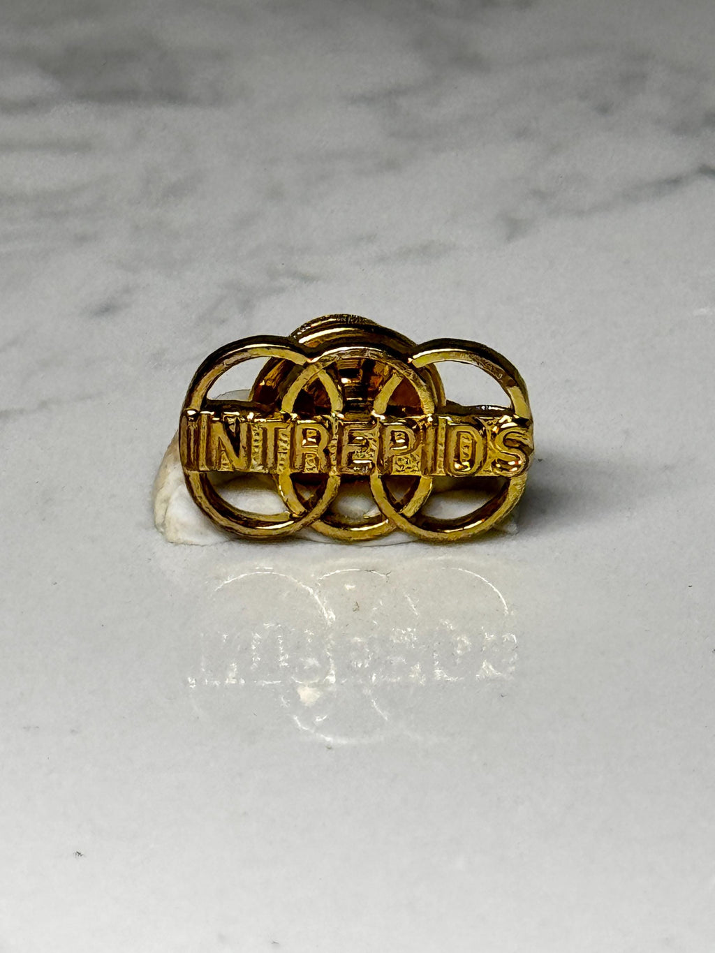 Vintage INTREPIDS Lapel Pin: Gold Tone Team Club Badge – Rings Design