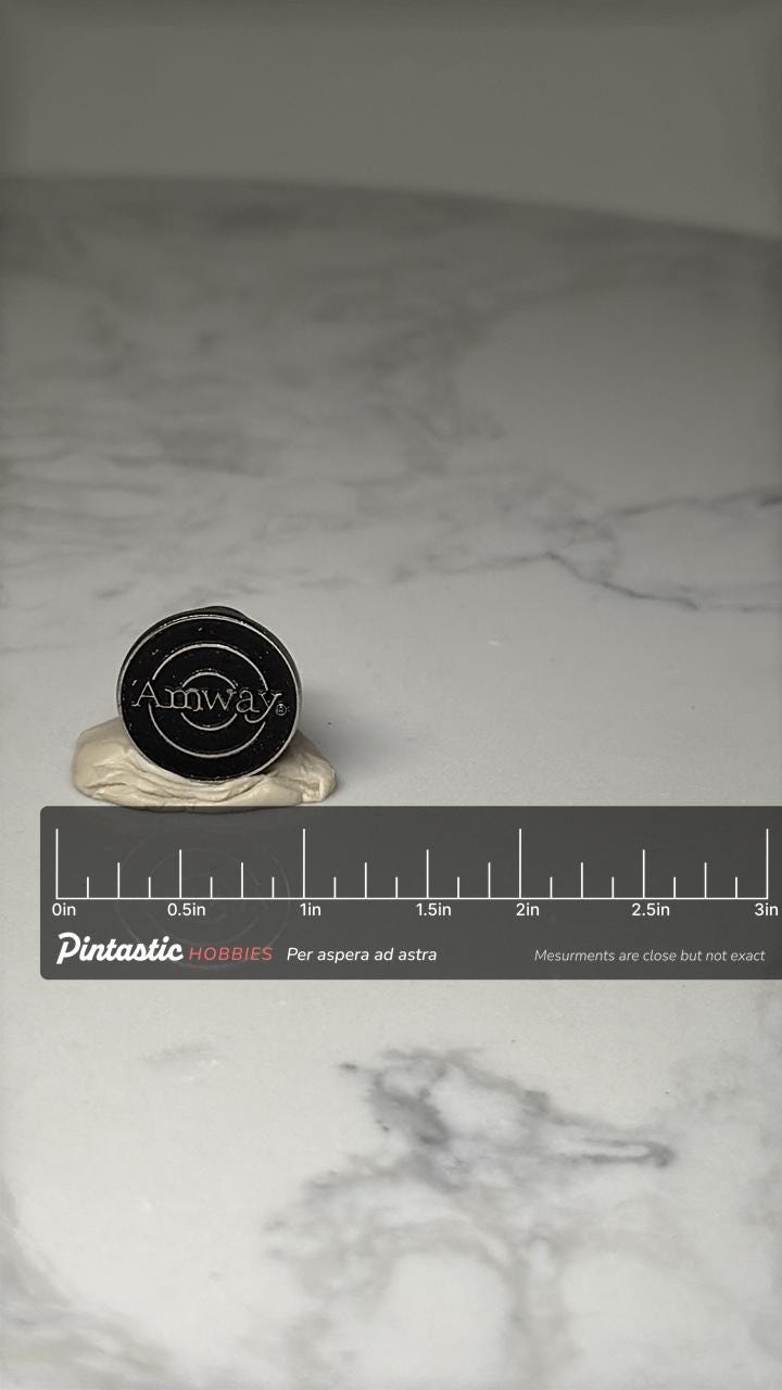 Amway Logo Lapel Pin: Black Enamel Silver Tone - Corporate Accessory with ruler overlay for size reference