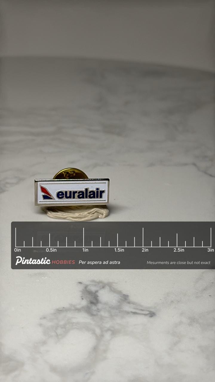 Euralair Airline Pin: White Enamel Logo - Aviation Collectible with ruler overlay for size reference