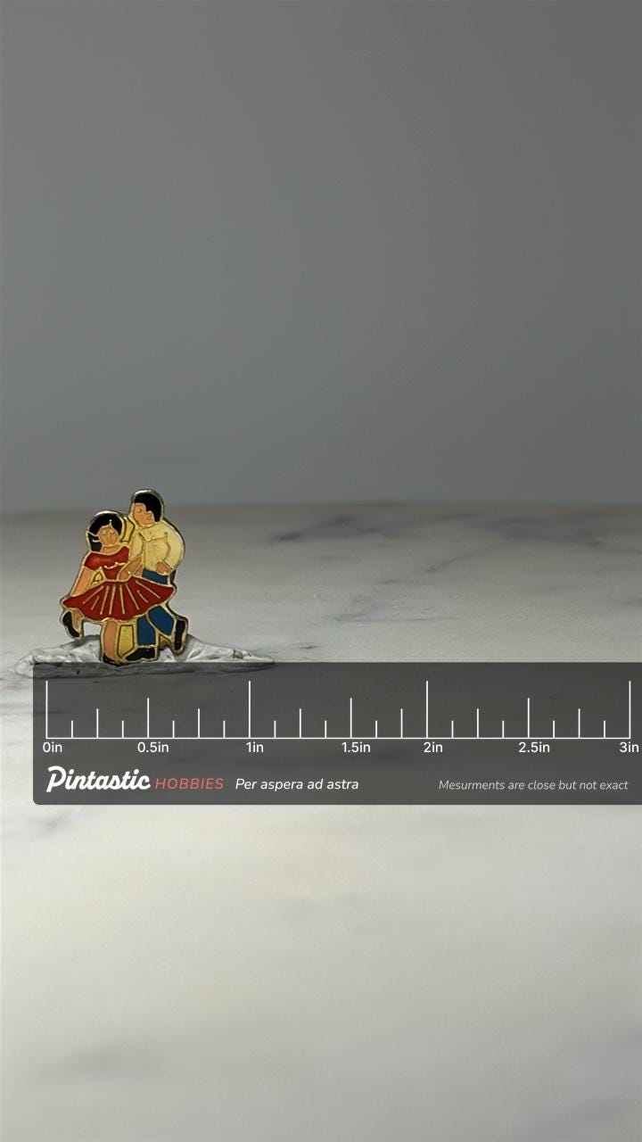 Vintage Dancing Couple Enamel Pin: Gold Tone - Retro Folk Accessory with ruler overlay for size reference