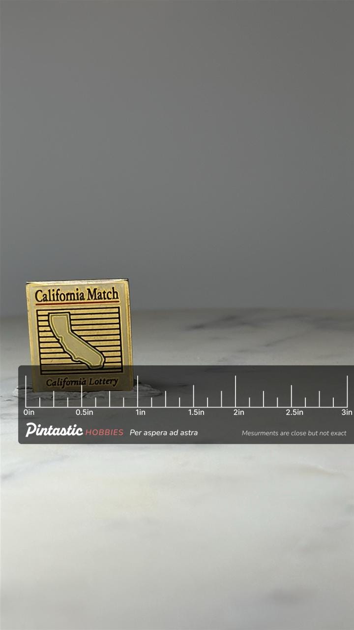 California Lottery Lapel Pin: Gold Tone Enamel - 1990s State Souvenir with ruler overlay for size reference