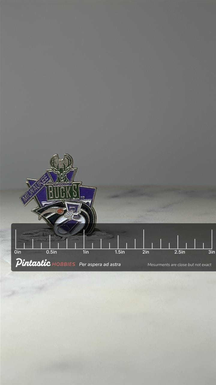 Milwaukee Bucks NBA Pin: Purple Enamel Logo - 1990s Sports Accessory with ruler overlay for size reference