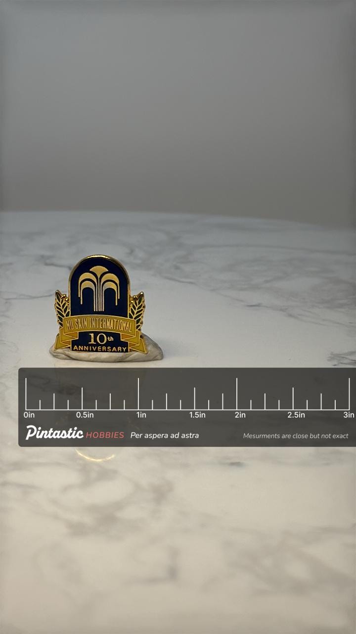 Vintage Nu Skin International 10th Anniversary Pin: Gold Enamel - Corporate Award with ruler overlay for size reference